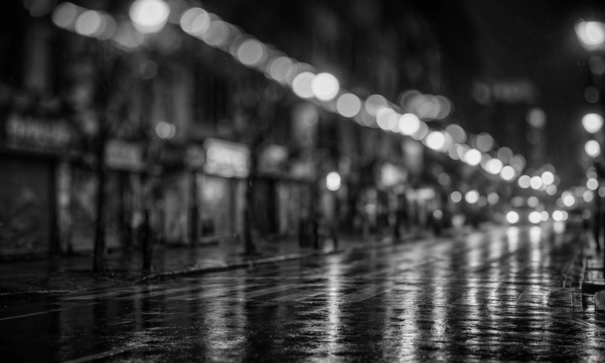 Black-and-white illustration of a nighttime street with blurred emergency lights