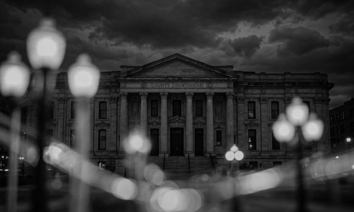 Black and white illustration of a courthouse at night